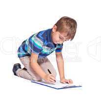 Boy writes in his diary. Isolated over white background.