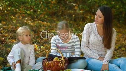 Mother And Children At Picnic In The Park