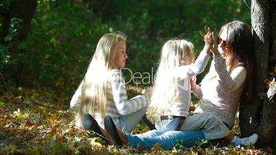 Happy Mother And Two Daughters Talking Together