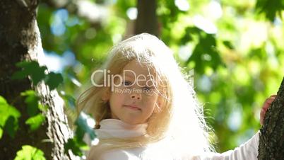 Two Blonde Little Girls On a Tree
