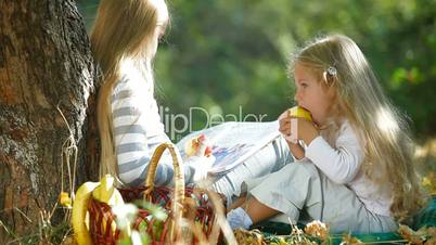 Two Blonde Little Girls Resting In The Park