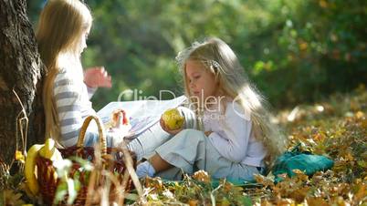 Children Reading Book In The Autumn Park