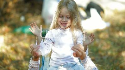 Happy Mother and Child Playing Outdoors