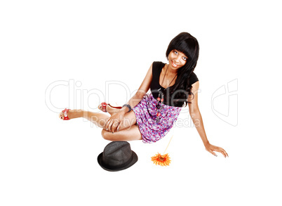 Black girl sitting on floor.