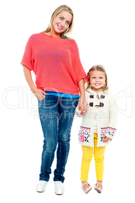Mum and daughter posing in trendy outfits
