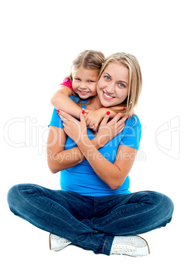 Cute daughter hugging her mother from behind