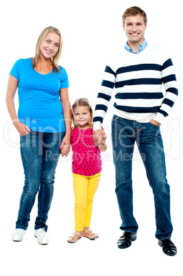 Sweet little kid standing in between her parents