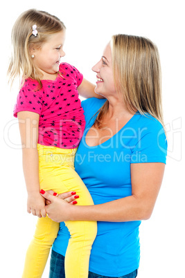 Gorgeous mother holding her beautiful daughter in arms