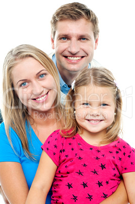 Parents posing with cute smiling daughter