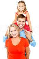 Portrait of cheerful family of three having fun