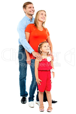 Couple with their girl child looking upwards