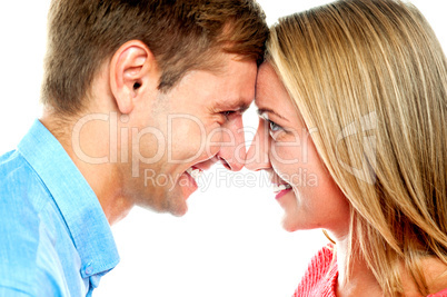 Smiling couple posing. Foreheads touching