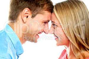 Smiling couple posing. Foreheads touching