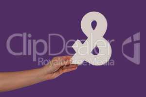 Female hand holding up an ampersand from the left