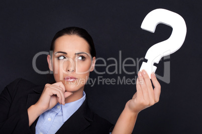 Businesswoman holding a question mark