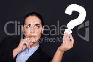 Businesswoman holding a question mark