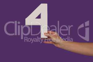 Female hand holding up the number 4 from the right