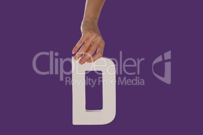 Female hand holding up the letter D from top