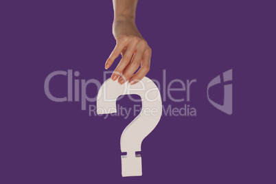 Female hand holding up a question mark from the top