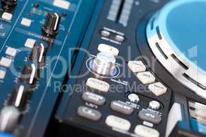 Closeup detail of a DJs deck with turntable