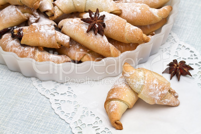 Freshly baked croissants with powdered sugar.