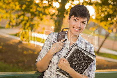 Portrait of a Pretty Mixed Race Female Student Holding Books