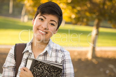 Portrait of a Pretty Mixed Race Female Student Holding Books