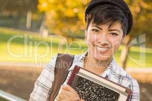 Portrait of a Pretty Mixed Race Female Student Holding Books