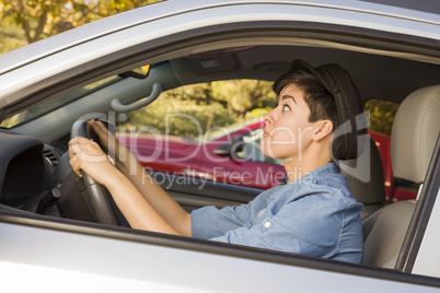 Stressed Mixed Race Woman Driving in Car and Traffic