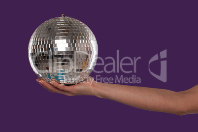 Female hand cupping a silver disco ball