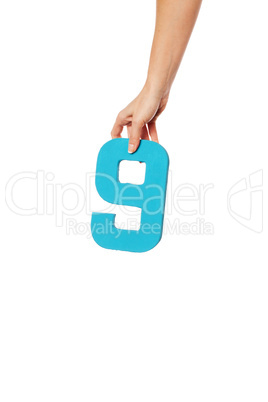 hand holding up the number nine from the top