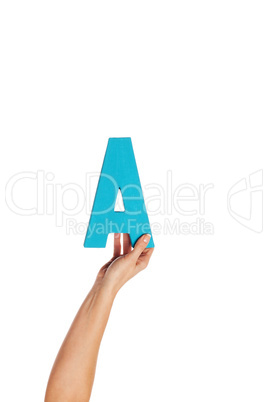 hand holding up the letter A from the bottom