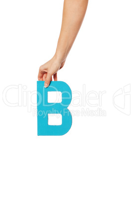 hand holding up the letter B from the top