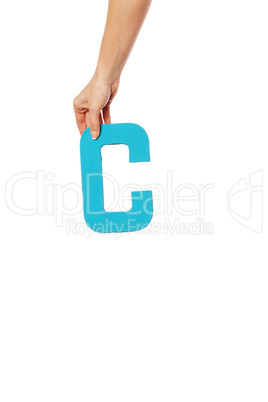 hand holding up the letter C from the top