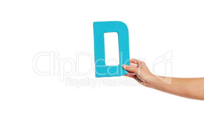 hand holding up the letter D from the right