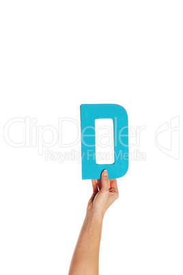 hand holding up the letter D from the bottom