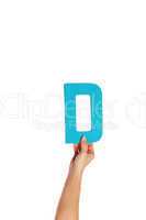 hand holding up the letter D from the bottom