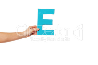 hand holding up the letter E from the left