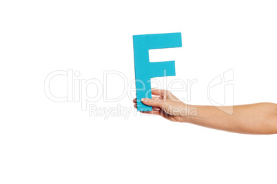 hand holding up the letter F from the right