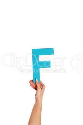 hand holding up the letter F from the bottom