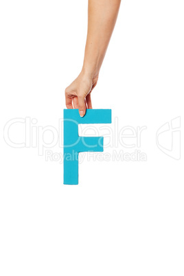 hand holding up the letter F from the top
