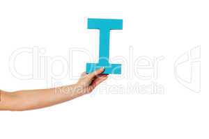 hand holding up the letter I from the left