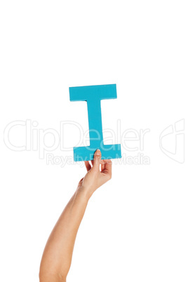 hand holding up the letter I from the bottom