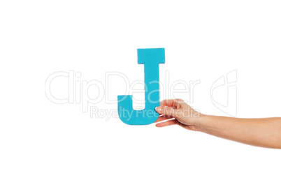 hand holding up the letter J from the right