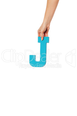 hand holding up the letter  from the top