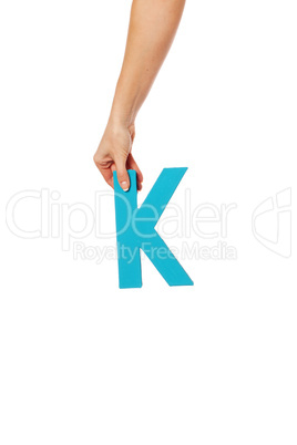 hand holding up the letter K from the top