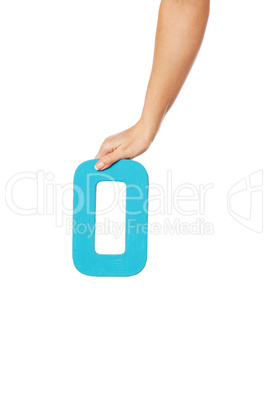 hand holding up the letter O from the top