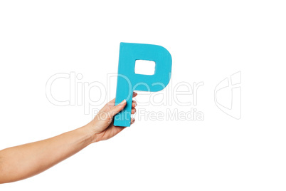 hand holding up the letter P from the left