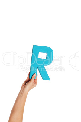 hand holding up the letter R from the bottom