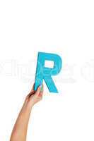 hand holding up the letter R from the bottom